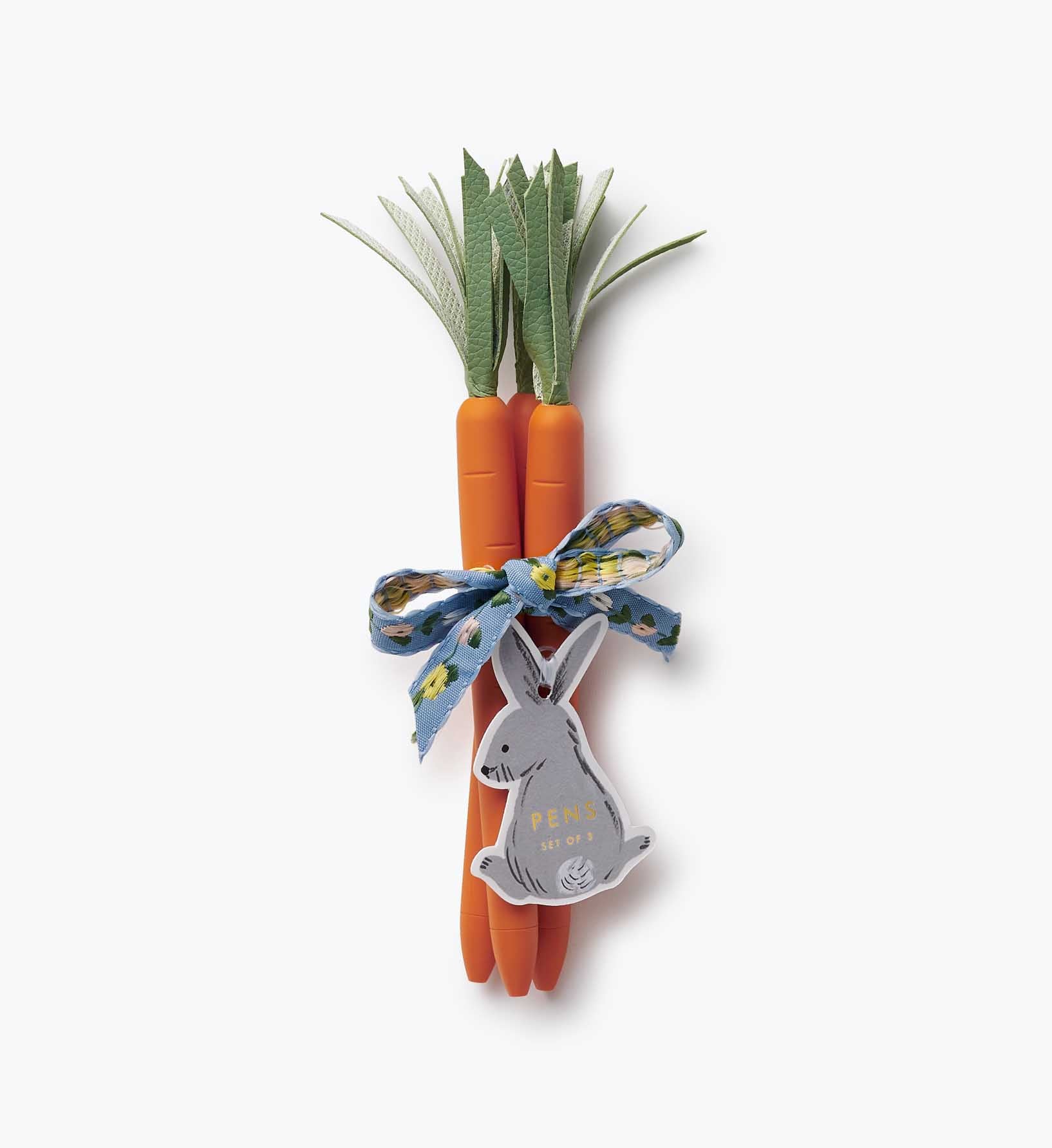 Three carrot-shaped pens with a bunny tag on a white background